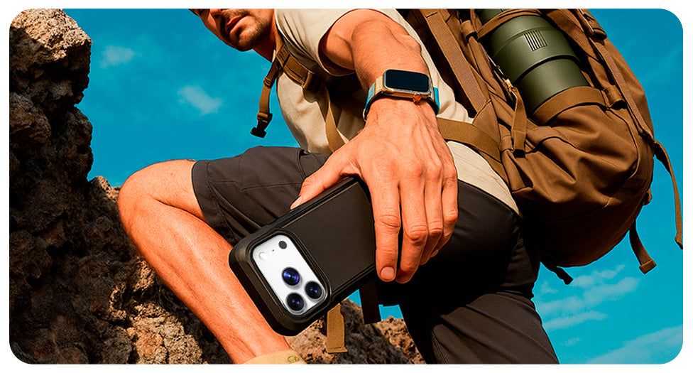 A man climbing a rock face with an iPhone 17 Pro Max in a Motivecase Bunker case securely attached to his gear.