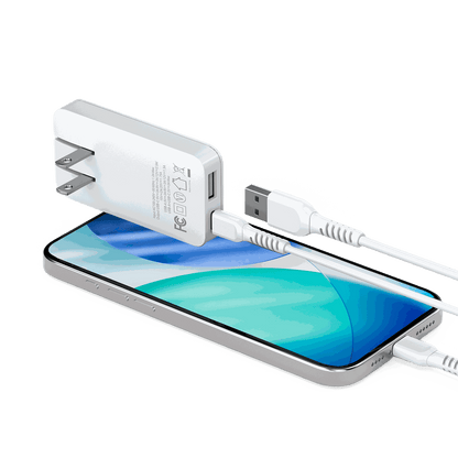 Lifestyle image showing the Motivecase 35W GaN charger setup with cables and a phone, ready to be used.