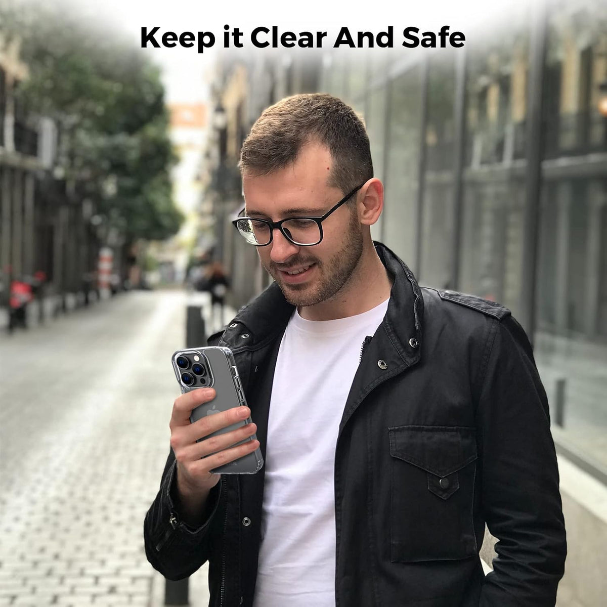 Person holding iPhone 14 Pro Max encased in Motivecase Crystal Clear Series transparent protective cover on city street highlighting clear design. **(21 words)**