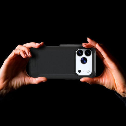 Hands holding Motivecase Bunker heavy-duty case for iPhone 17 Pro Max horizontally taking photos against dark background.