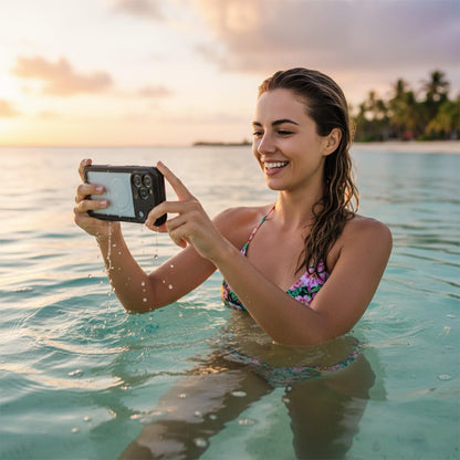 Motivecase Waterproof clear phone case for iPhone 17 Pro Max with water droplets lying on beach sand during an outdoor ocean lifestyle trip. **(23 words)**