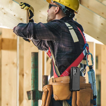 Construction worker on a job site with the heavy-duty Motivecase Bunker Samsung Galaxy S25 Ultra case clipped securely to a tool belt.